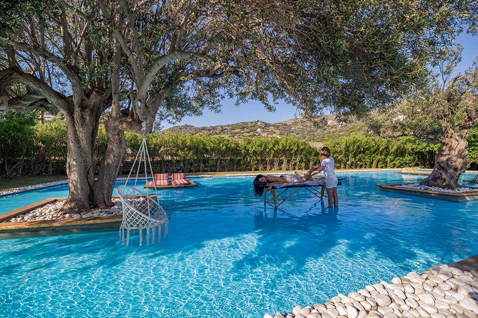 Poolside massage under olive trees at the Ow Andros pool lounge