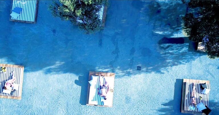 Aerial view of guests resting on submerged loungers