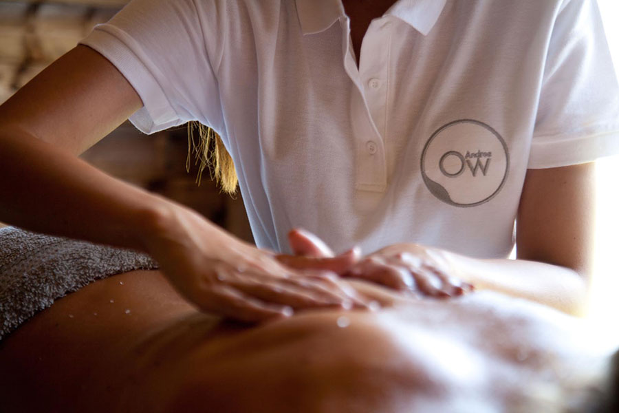 Therapist in Ow Andros uniform performing a back massage