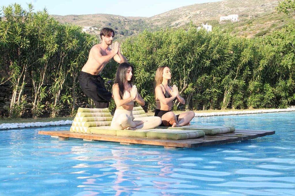 Meditation session on a floating platform in the pool at Ow Andros, Andros Island